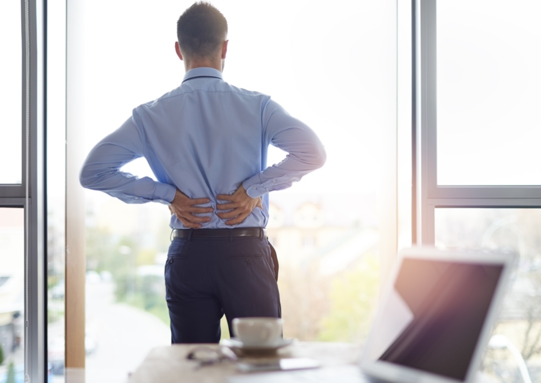 Chiropractor treating lower back pain from prolonged sitting at Battersea & Chelsea Chiropractic—relieving postural strain in Chelsea, Battersea, and SW London.