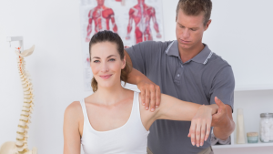 Male chiropractor from Battersea and Chelsea Chiropractic going a female patient a chiropractic treatment instead of a physio