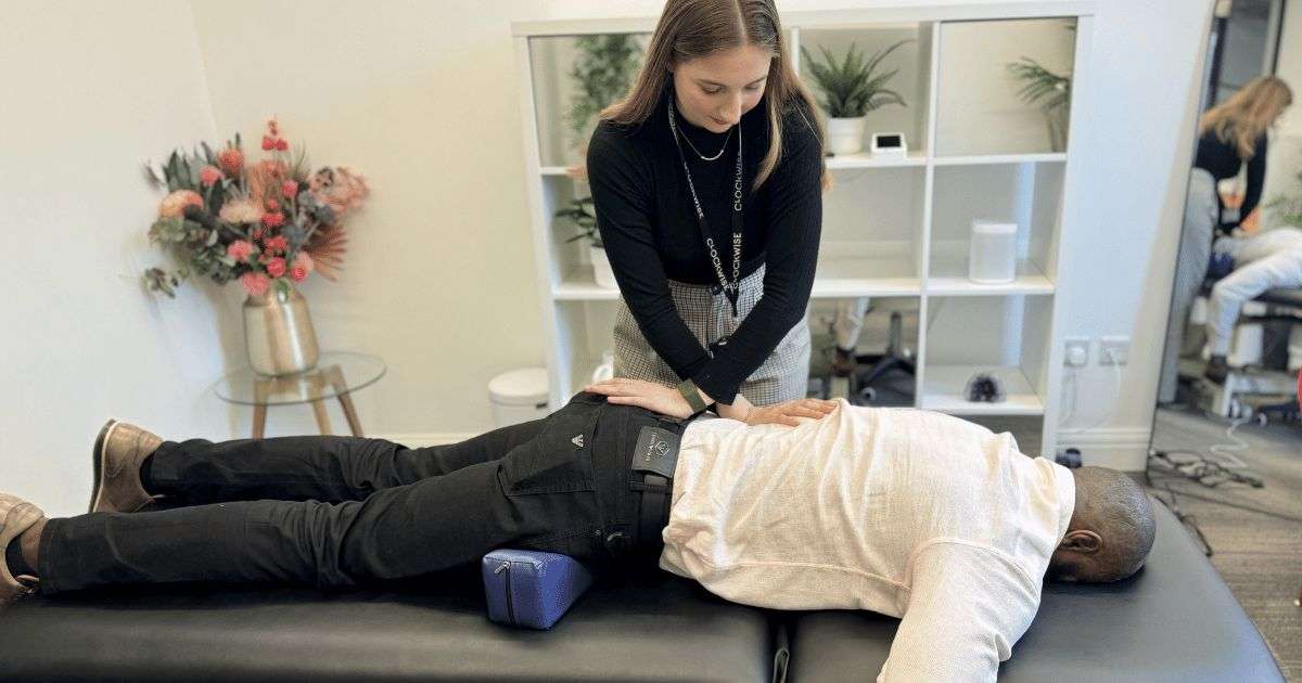 Practitioner assessing a patient’s shoulder and neck during musculoskeletal treatment