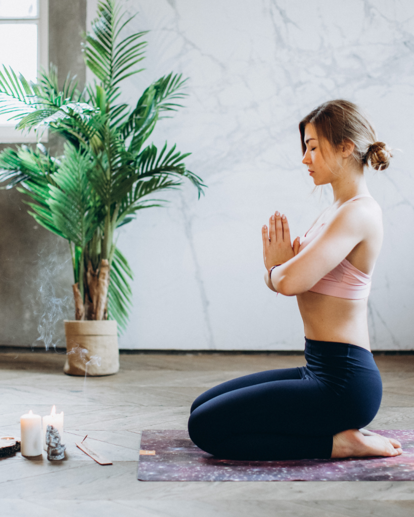 lady relaxed happy and doing a yoga mediation after her relaxing treatment with Chiropractor in Wandsworth at Battersea and Chelsea Chiropractic