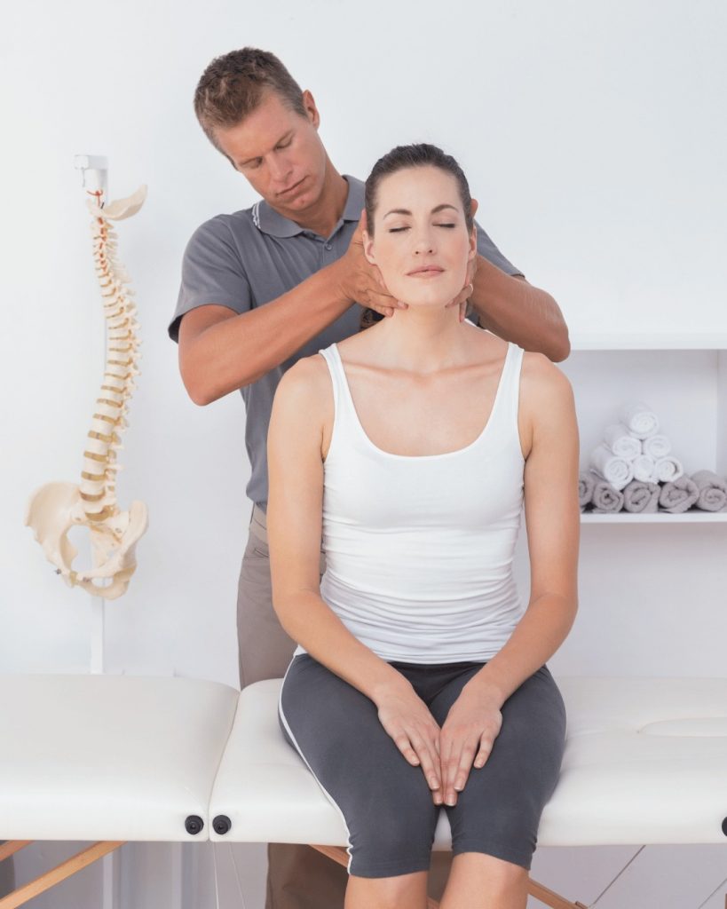 Chiropractor performing a spinal adjustment on a patient near London Victoria clinic.