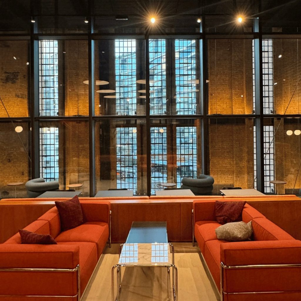 Lounge space inside Battersea Power Station chiropractic clinic with seating and relaxing ambience.