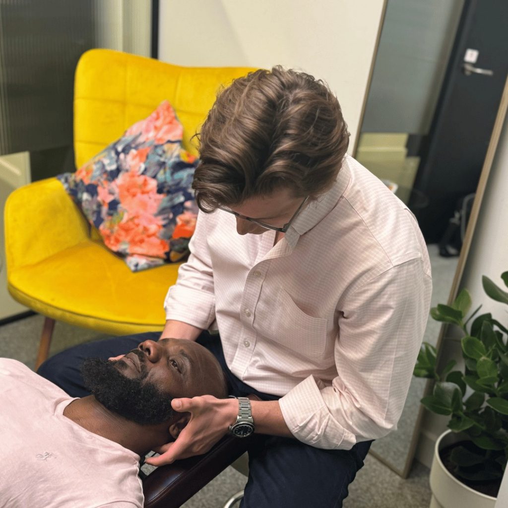 Chiropractor delivering a spinal adjustment to a patient at our London clinic inside Battersea Power Station.