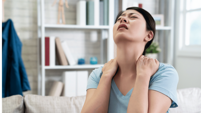image showing a patient gently touching their neck in a calm, modern clinic environment with an anatomical illustration of the cervical spine, designed for Battersea & Chelsea Chiropractic London.