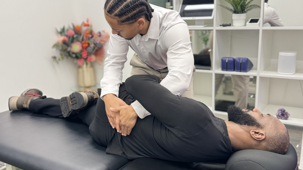 Battersea Chiropractor helping someone with lower back pain after explaining to them what causes lower back pain